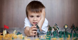 Cute,Little,Toddler,Boy,,Playing,At,Home,With,Soldiers,And