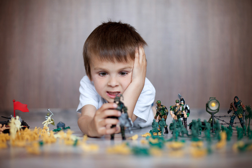 Cute,Little,Toddler,Boy,,Playing,At,Home,With,Soldiers,And