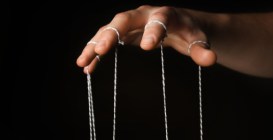 Hand,Of,Puppeteer,On,Dark,Background