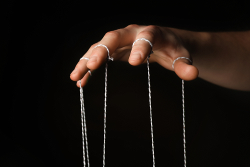 Hand,Of,Puppeteer,On,Dark,Background