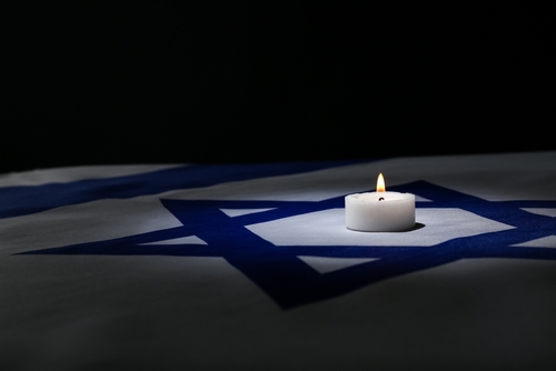 Burning,Candle,On,Flag,Of,Israel,Against,Dark,Background,With Burning,Candle,On,Flag,Of,Israel,Against,Dark,Background,With