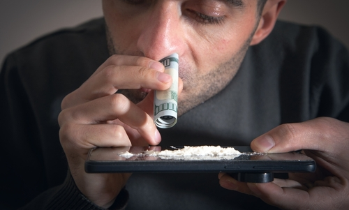 Caucasian,Man,Sniffing,Cocaine,At,Home.